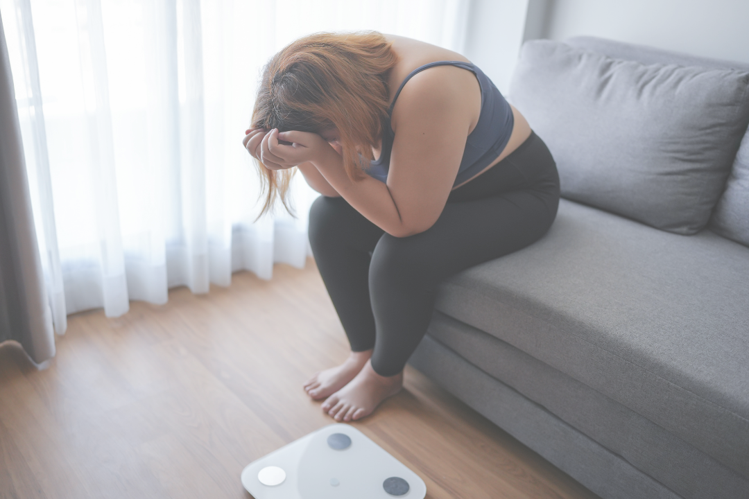Woman crying on the couch because of her health