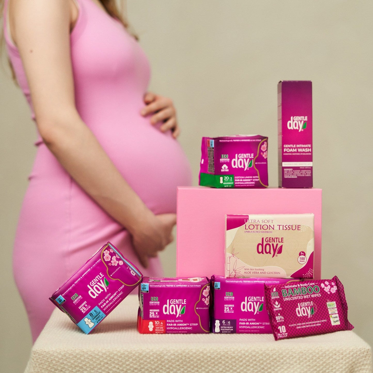 Pregnant woman stands near Gentle Day postpartum kit
