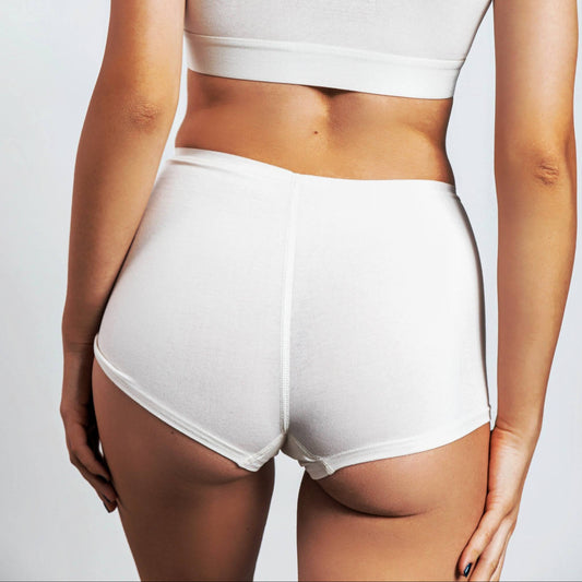 A rear view of a person wearing a white high-rise boyshort panty